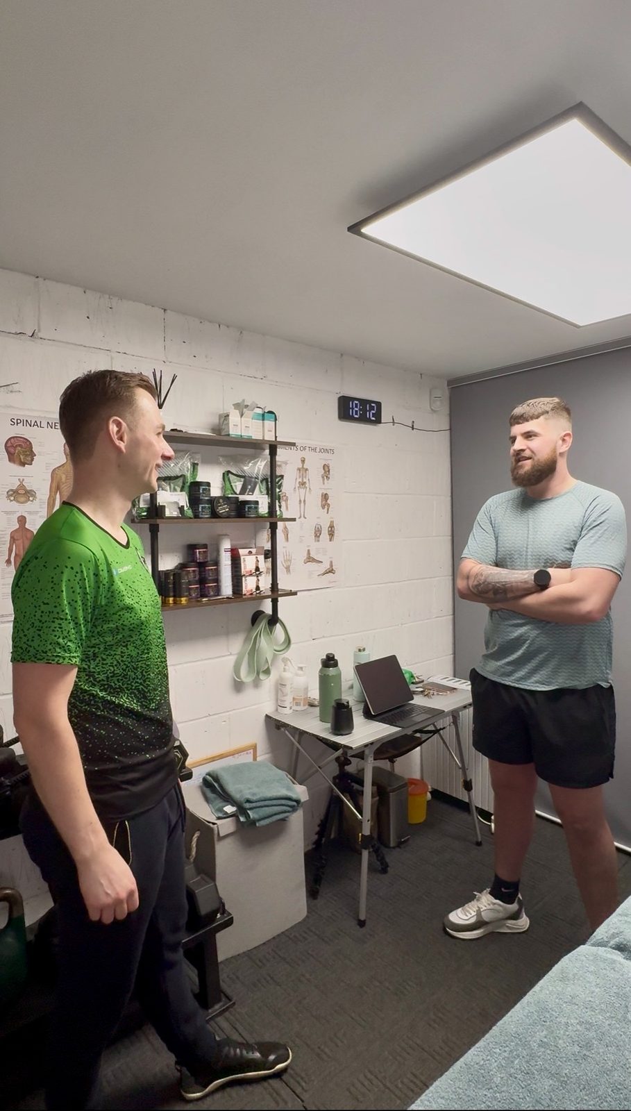 Jake Harrison talking through an assessment with a client at his Sheffield sports therapy clinic
