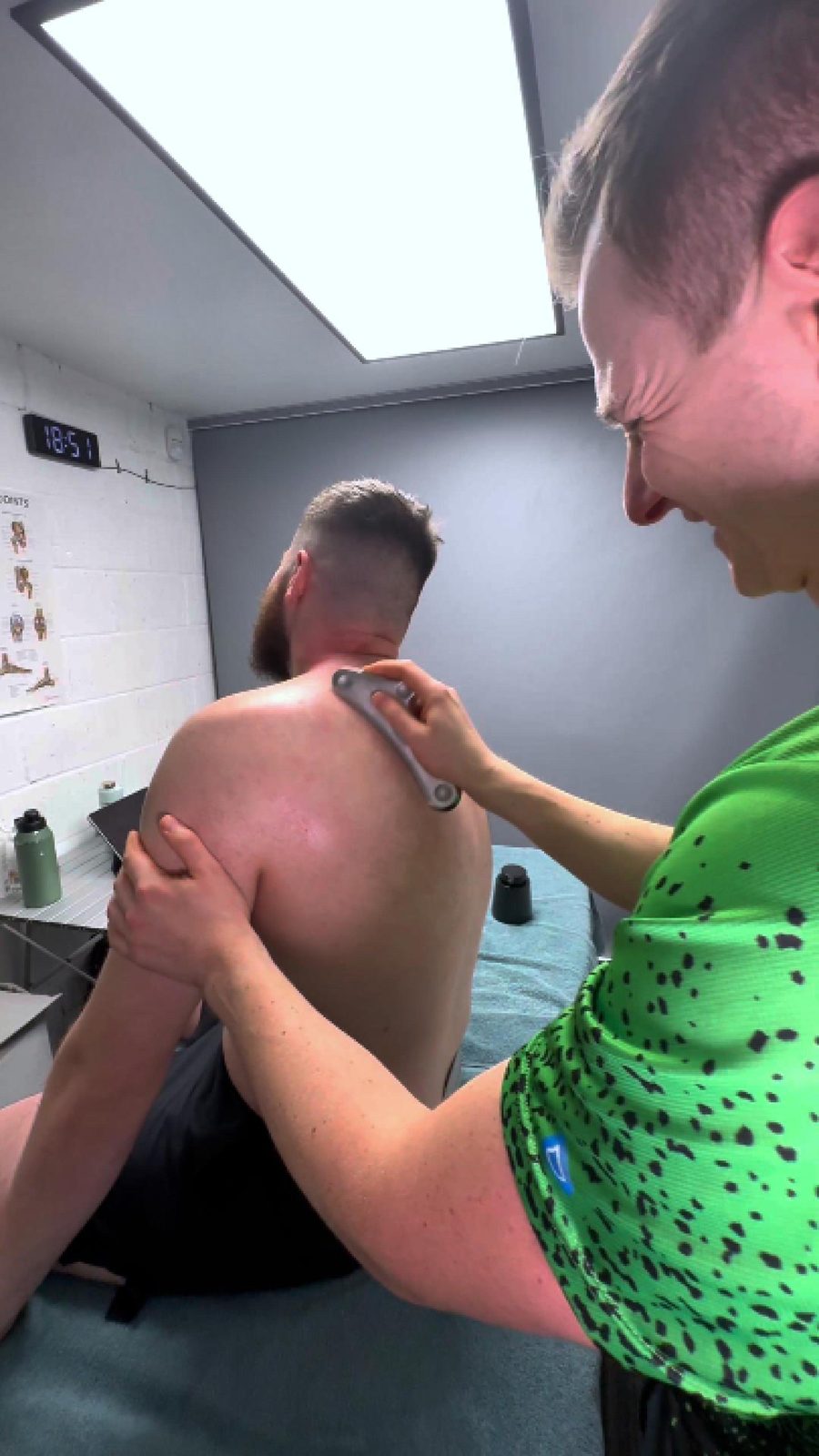 Instrument assisted soft tissue treatment on a client's shoulder at the Halfway S20 clinic