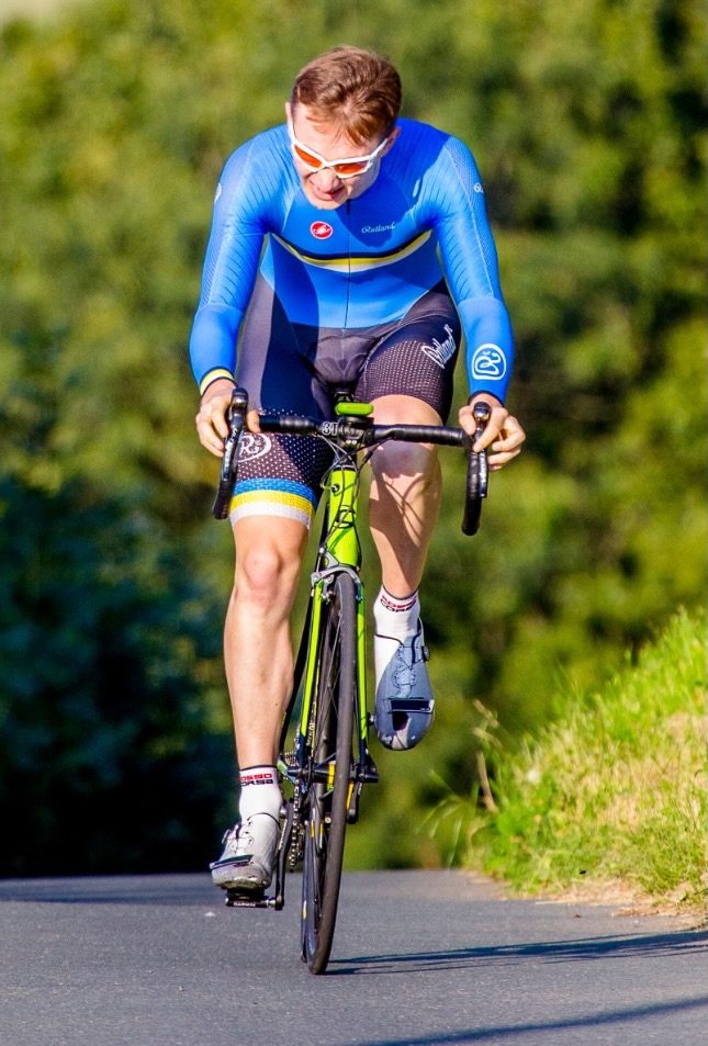Jake Harrison riding a road cycling event after rehab from hip surgery